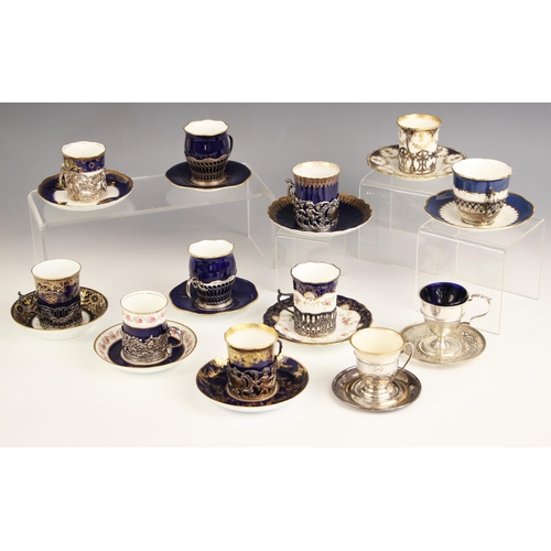 36 - A selection of silver mounted coffee cans and saucers, to include a Coalport coffee can and saucer, ... 