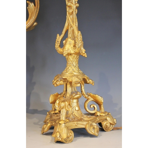 526 - A pair of French gilt metal Rococo style desk lamps, early 20th century, each formed with naturalist... 