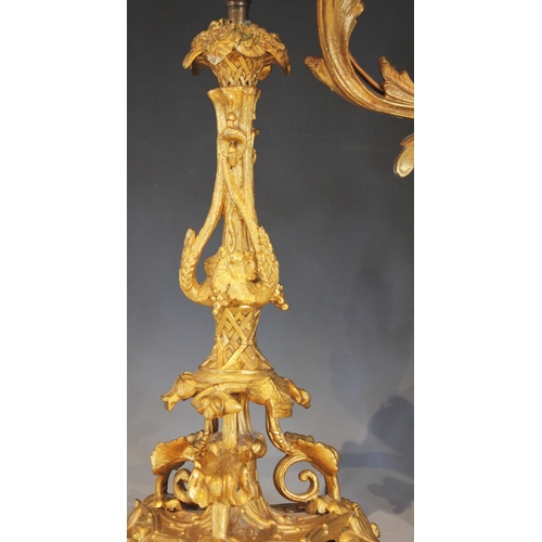 526 - A pair of French gilt metal Rococo style desk lamps, early 20th century, each formed with naturalist... 