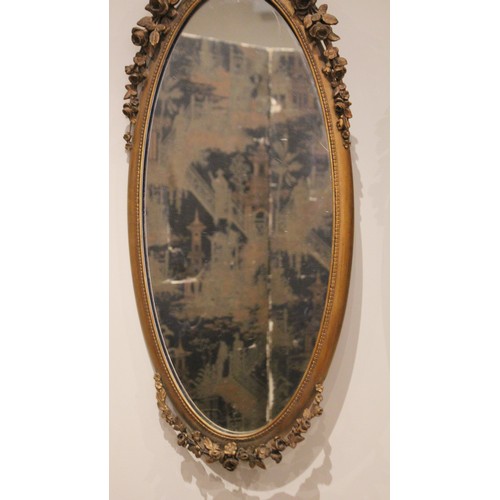 685 - A pair of French giltwood and gesso wall mirrors, late 19th/early 20th century, each with a ribbon t... 