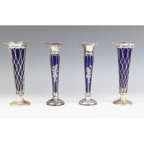 50 - A pair of Edwardian silver posy vases, Thomas Bradbury and Sons Ltd, Birmingham 1906, the flared rim... 