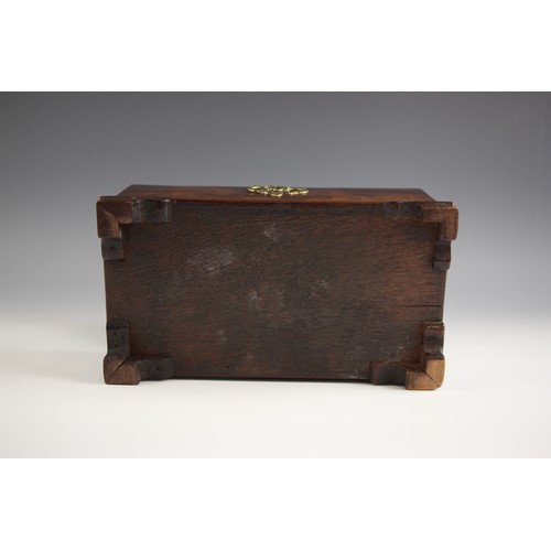 677 - A George III flame mahogany tea caddy, of sarcophagus form, the hinge cover applied with brass swan ... 