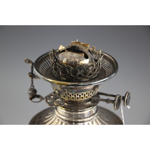 6 - A Victorian silver oil lamp, James Deakin and Sons, Sheffield 1891, the urn shaped body with embosse... 