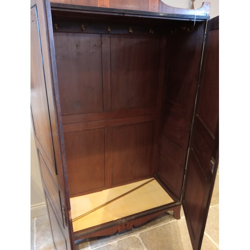 730 - A late George III mahogany wardrobe, possibly Channel Islands, the arched cornice inlaid with stylis... 