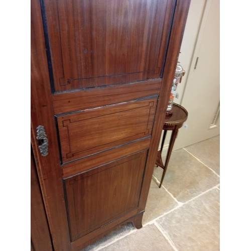 730 - A late George III mahogany wardrobe, possibly Channel Islands, the arched cornice inlaid with stylis... 