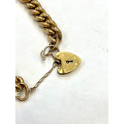 157 - A yellow metal hollow link bracelet, the curb link bracelet with engraved floral decoration to each ... 