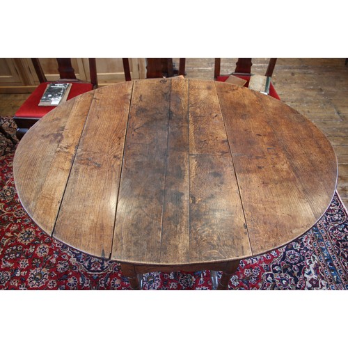 709 - A late 17th century oak gate leg table, the oval plank top above a single frieze drawer, upon ring t... 