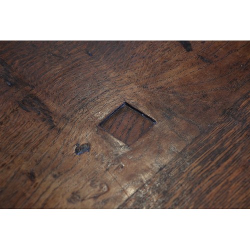 709 - A late 17th century oak gate leg table, the oval plank top above a single frieze drawer, upon ring t... 