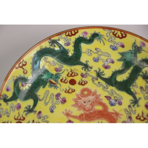 348 - A Chinese porcelain yellow ground dragon dish, Qianlong seal mark, the shallow circular dish central... 