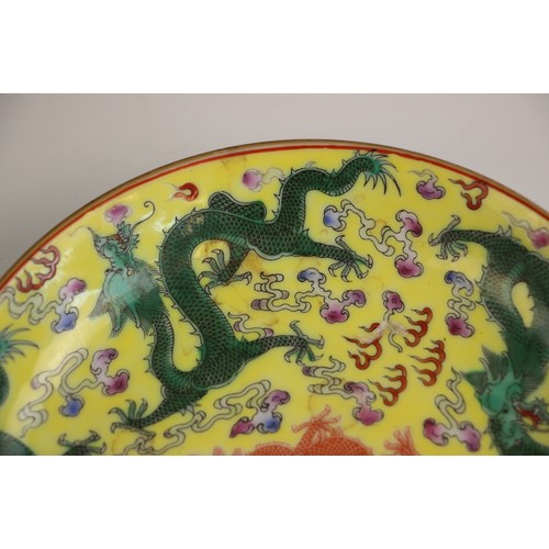 348 - A Chinese porcelain yellow ground dragon dish, Qianlong seal mark, the shallow circular dish central... 