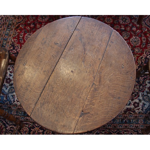 718 - A George III oak tripod table, the circular top upon a plain cylindrical pedestal extending to three... 