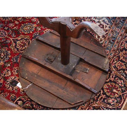 718 - A George III oak tripod table, the circular top upon a plain cylindrical pedestal extending to three... 