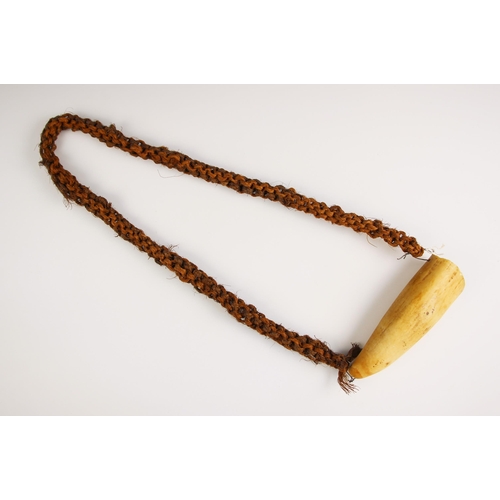 100 - A Fijian tabua, (ceremonial whale tooth) tooth 16cm wide, with coconut fibre cord sennit 44cm long o... 