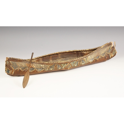 103 - A North American mic mac model canoe with paddle, late 19th century, of birch bark and porcupine qui... 