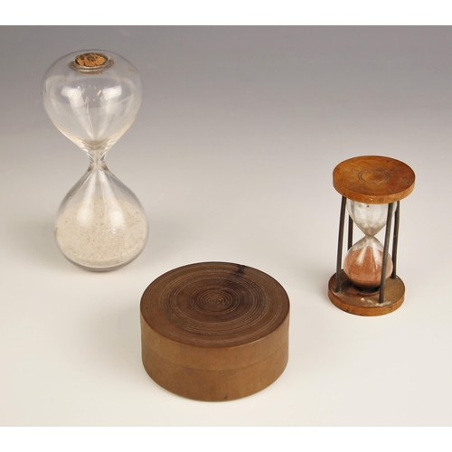 249 - A 19th century glass sand timer, of typical form, with cork stopper, 12cm high, a second smaller exa... 