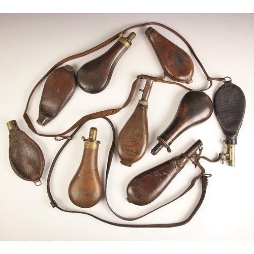 274 - A 19th century leather powder shot flask, of typical pear form, embossed with game birds and a hound... 