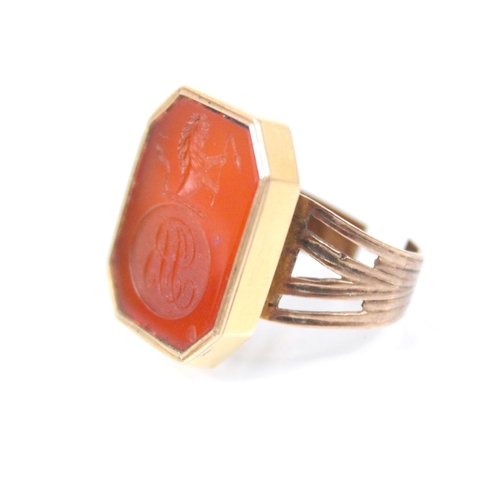 28 - A 19th century carnelian seal ring, the octagonal intaglio with ‘RB’ monogram within oval cartouche ... 