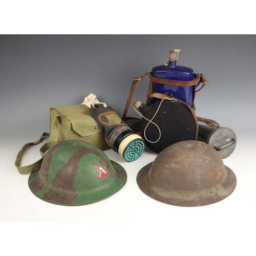 319 - WORLD WAR I/II INTEREST: A World War I British Brodie rimless combat helmet, first pattern, one side... 