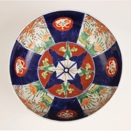 330 - A Japanese porcelain bowl, Meiji period (1868-1912) decorated in the imari palette with a panelled d... 