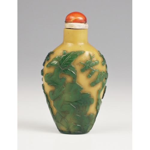 336 - A Chinese Peking glass green overlay, yellow snuff bottle, 19th century, of high shouldered form, de... 