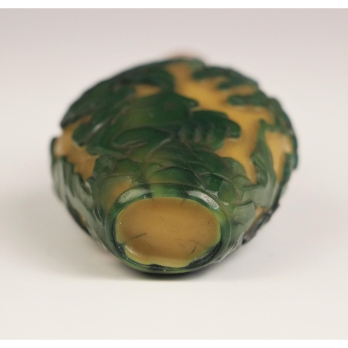 336 - A Chinese Peking glass green overlay, yellow snuff bottle, 19th century, of high shouldered form, de... 