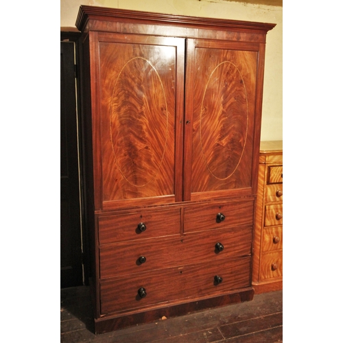 675 - * An early 19th century mahogany linen press, the moulded cornice over a pair of flame mahogany door... 