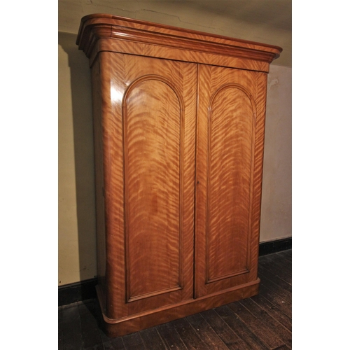 677 - * A Victorian satin birch two door wardrobe by P & J Smith, Glasgow, finished with a tiger stripe pa... 