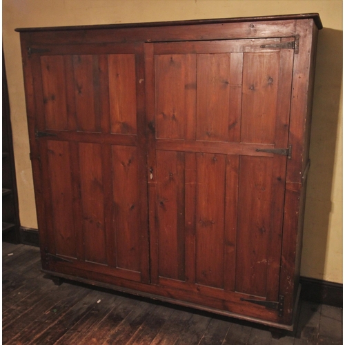 678 - * A Victorian stained pine hall cupboard, the twin panelled doors opening to four shelves, upon ogee... 