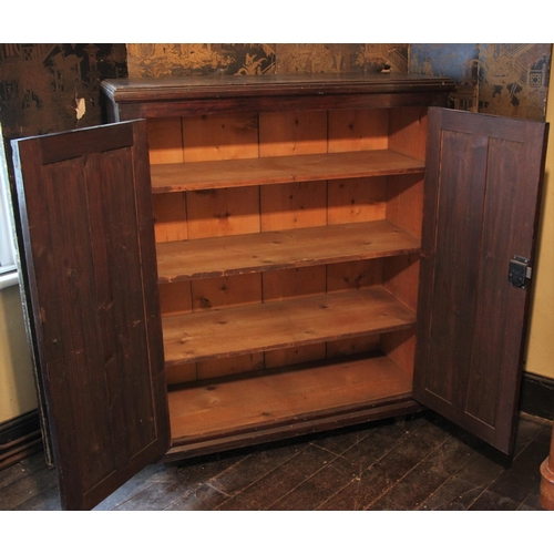 679 - * A Victorian ecclesiastical stained pine hall cupboard, the ogee panelled twin doors opening to thr... 