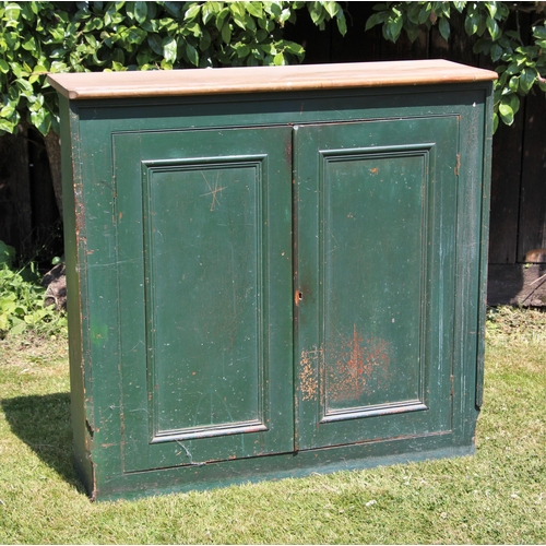 682 - * A Victorian pine and green painted cupboard, the rectangular pine top over a pair of panelled door... 