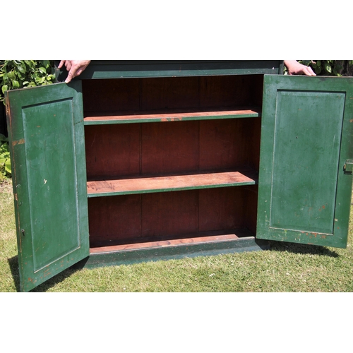 682 - * A Victorian pine and green painted cupboard, the rectangular pine top over a pair of panelled door... 