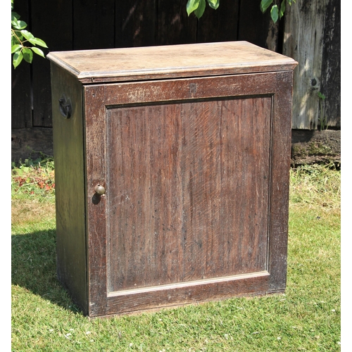 689 - * A Victorian scumbled pine cabinet, applied with iron side swing handles, the single door opening t... 