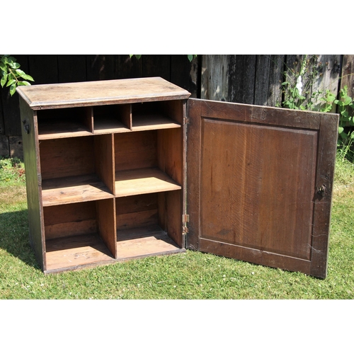 689 - * A Victorian scumbled pine cabinet, applied with iron side swing handles, the single door opening t... 