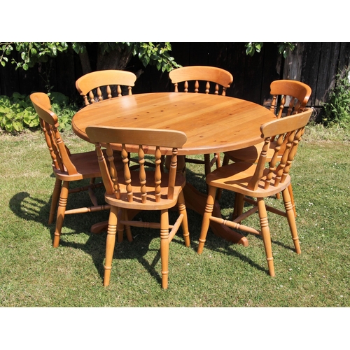 690 - * A Victorian style pine pedestal kitchen table, 20th century, upon a baluster column and three down... 