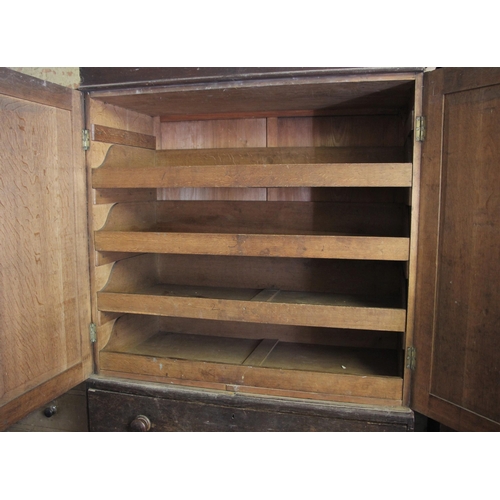 696 - * A 19th century oak linen press, the cavetto cornice over a pair of panelled doors opening to four ... 