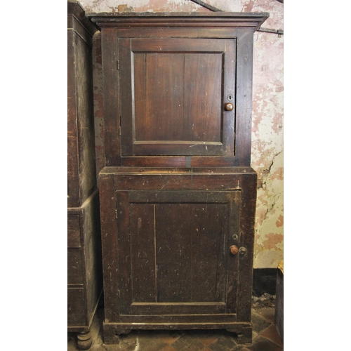 697 - * A 19th century stained pine pantry, the moulded cornice over two graduated cupboard doors, opening... 