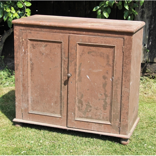 698 - * A Victorian painted pine kitchen cupboard, the moulded top over a pair of panelled doors opening t... 