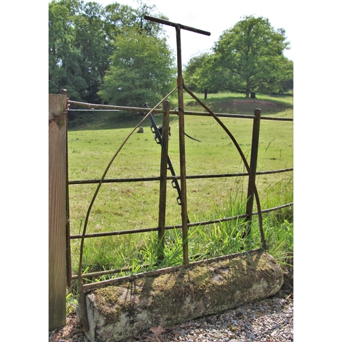 702 - * A sandstone and wrought iron garden roller 135cm H x 104cm W