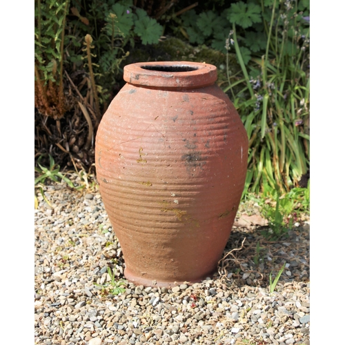 707 - * A terracotta ovoid shaped planter, 35cm high (at fault)