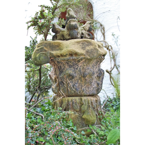 710 - * A pair of Acanthus sandstone capitals, on plinth base, 105cm H, topped with corbel (3)