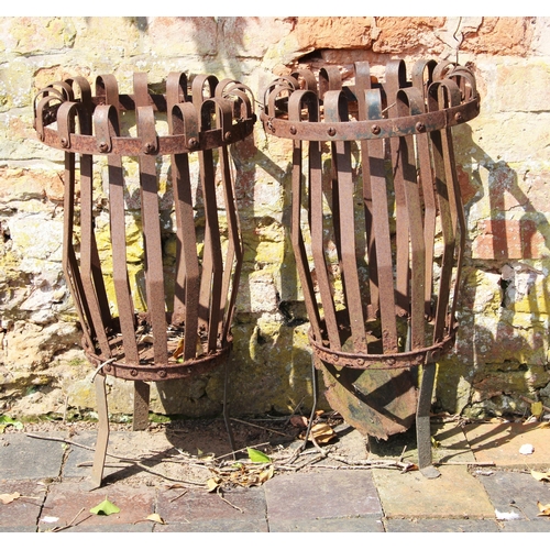 717 - * A pair of wrought iron strap-work planters, of tapering form with folded rims,