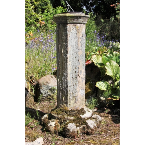 728 - * A sandstone plinth of hexagonal form, with sundial, raised on a capital, 105cm H