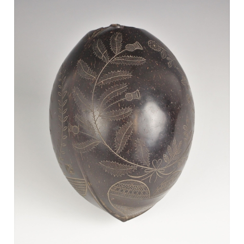 71 - An unusual carved and polished bugbear coconut flask or sailors token, early 19th century, incised w... 