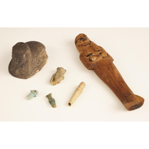 98 - An Egyptian wooden ushabti figure, the carved  shabti figure of typical form 17.7cm long, with a sca... 