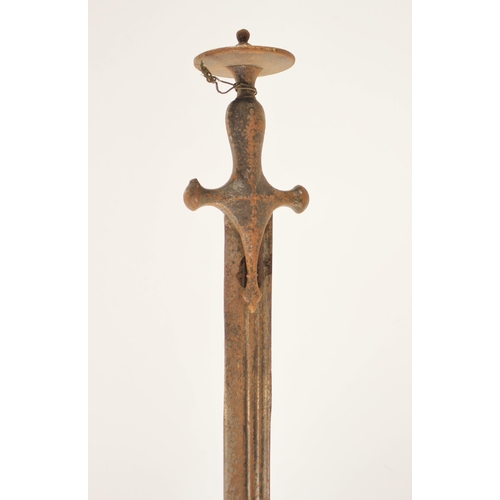 277 - An Indian Talwar, 18th/ 19th century, with curved fullered blade and iron hilt, the hilt with disc p... 