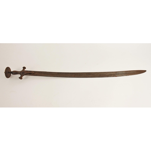 277 - An Indian Talwar, 18th/ 19th century, with curved fullered blade and iron hilt, the hilt with disc p... 