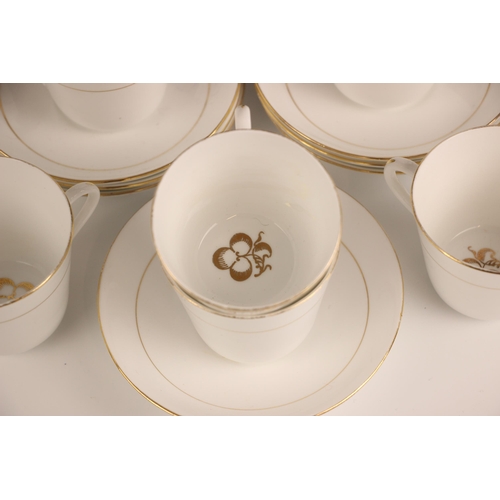 347 - A collection of Salon China teacups and saucers, each white glazed with gilt floral detail within gi... 