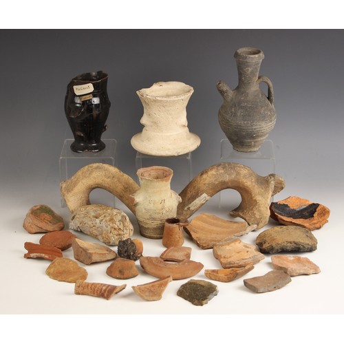 87 - A Roman blackware water vessel, 19.5cm high, two amphora handles, each bearing old collection labels... 