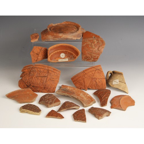 86 - A collection of Roman Samian Ware pottery fragments, to include a fragment bearing Royal Archaeologi... 