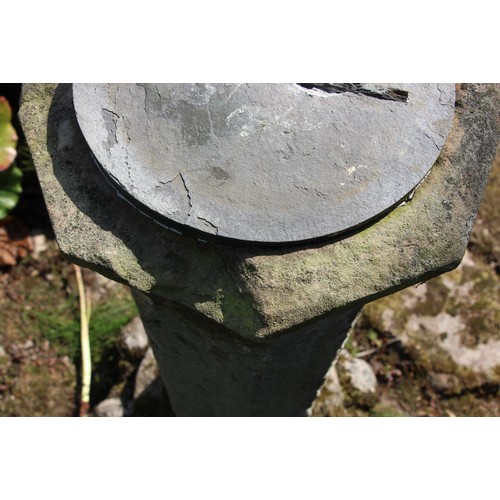 728 - * A sandstone plinth of hexagonal form, with sundial, raised on a capital, 105cm H